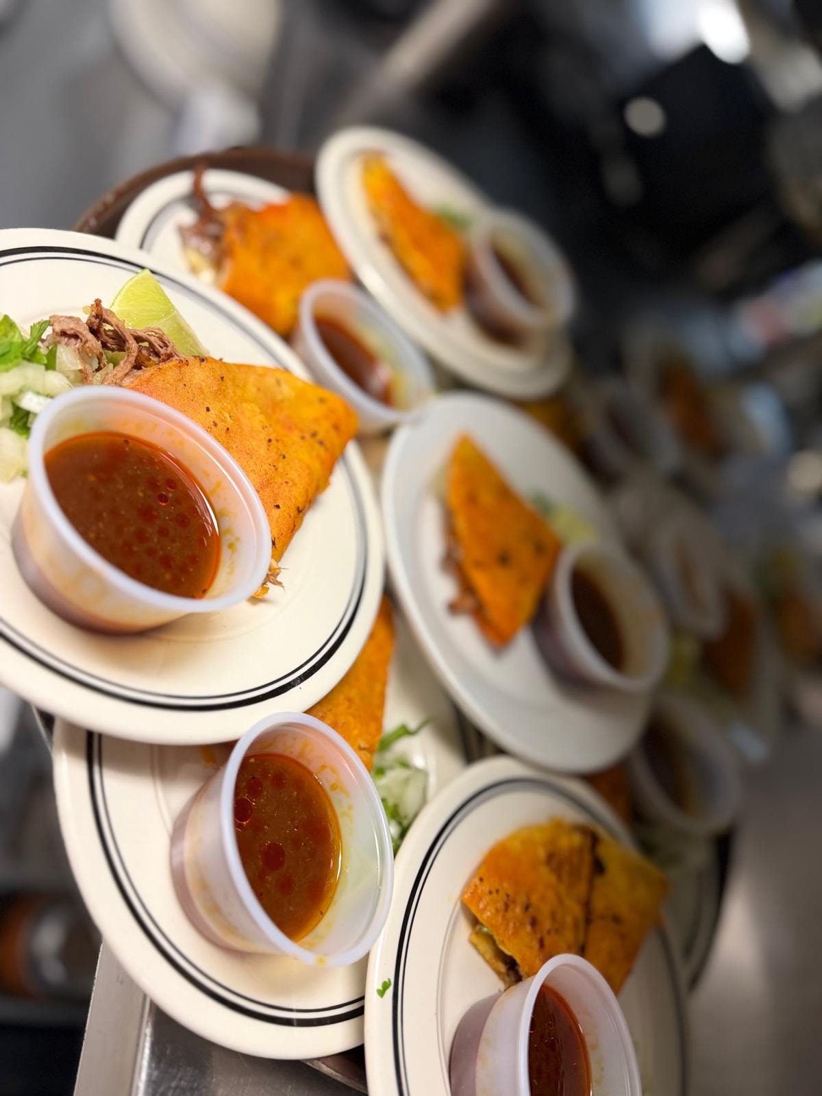 Birria tacos overhead tray with consomé at Westrail